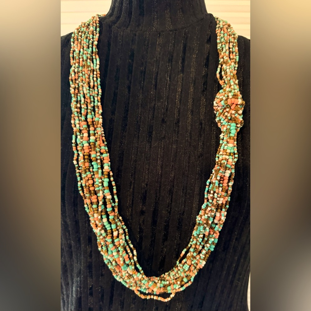 Beaded necklace. Coral, teal, white and bronze colored beads.